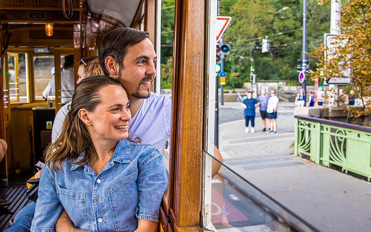 Couple enjoying view from historical tram in Prague.