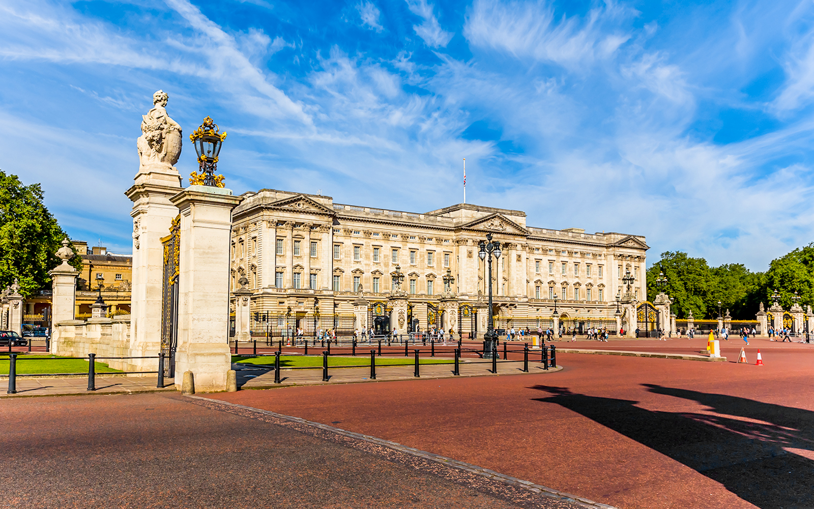 Buckingham Palace East Front with tourists gathered in London, England.