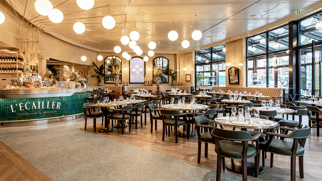 Brasserie Rosalie dining area set for breakfast with elegant decor and large windows.