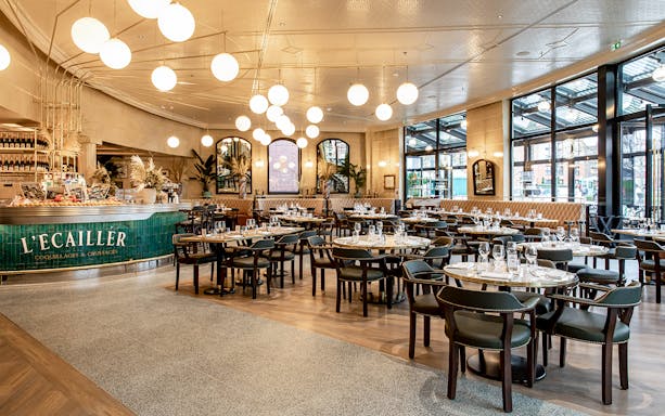 Breakfast spread at Brasserie Rosalie, Paris, featuring croissants, coffee, and fresh fruit.