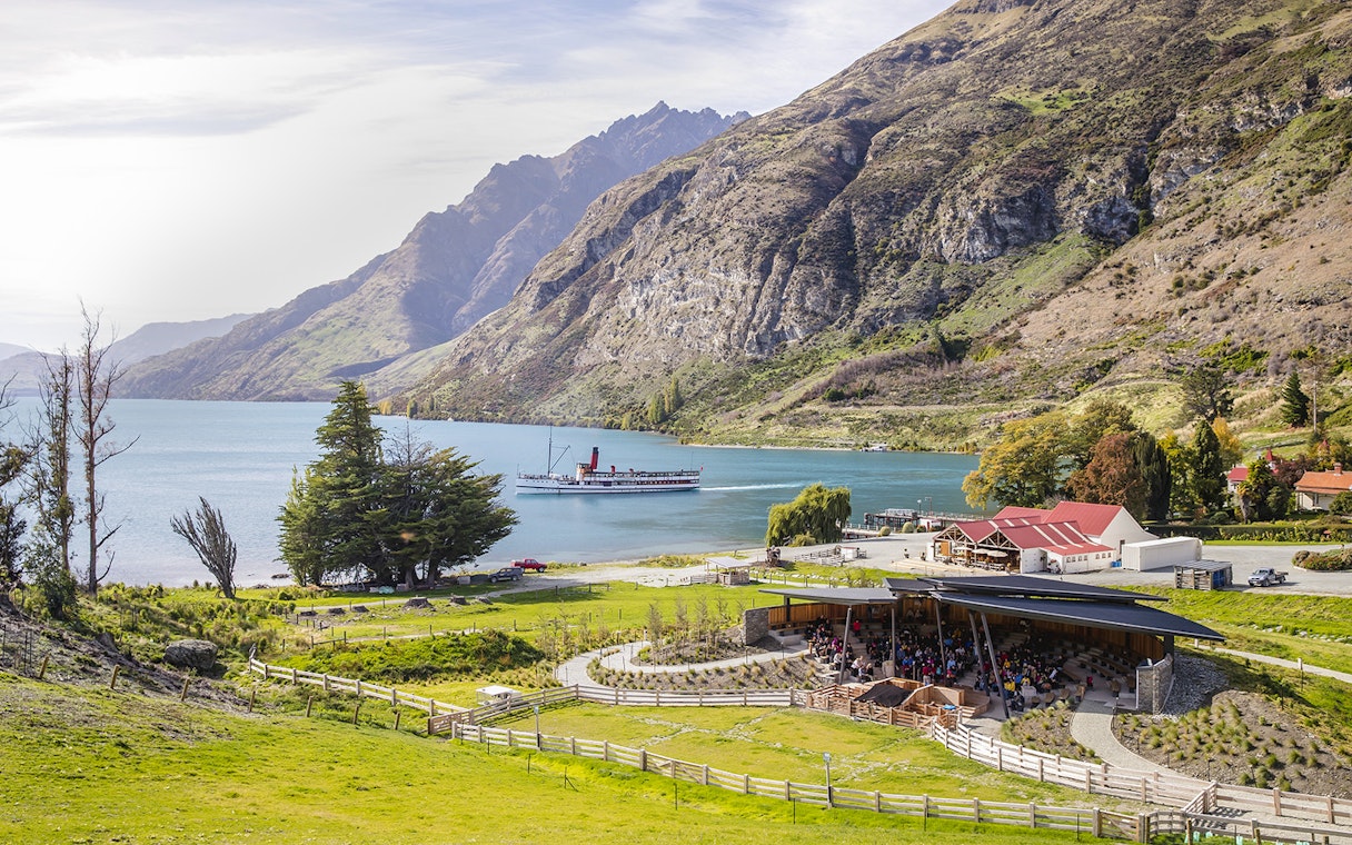 Walter Peak High Country Farm with steamboat on Lake Wakatipu, New Zealand.