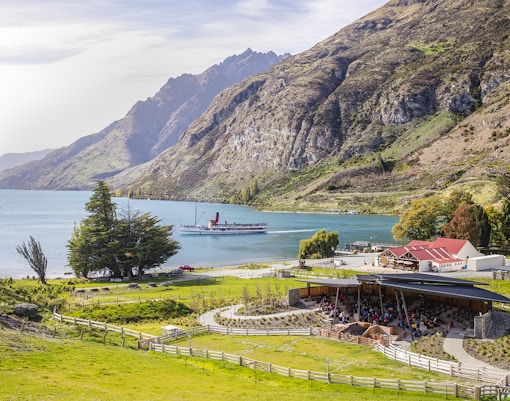 Walter Peak High Country Farm with steamboat on Lake Wakatipu, New Zealand.