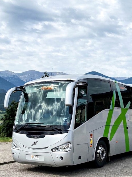 Bus traveling through scenic mountains near Andorra la Vella.