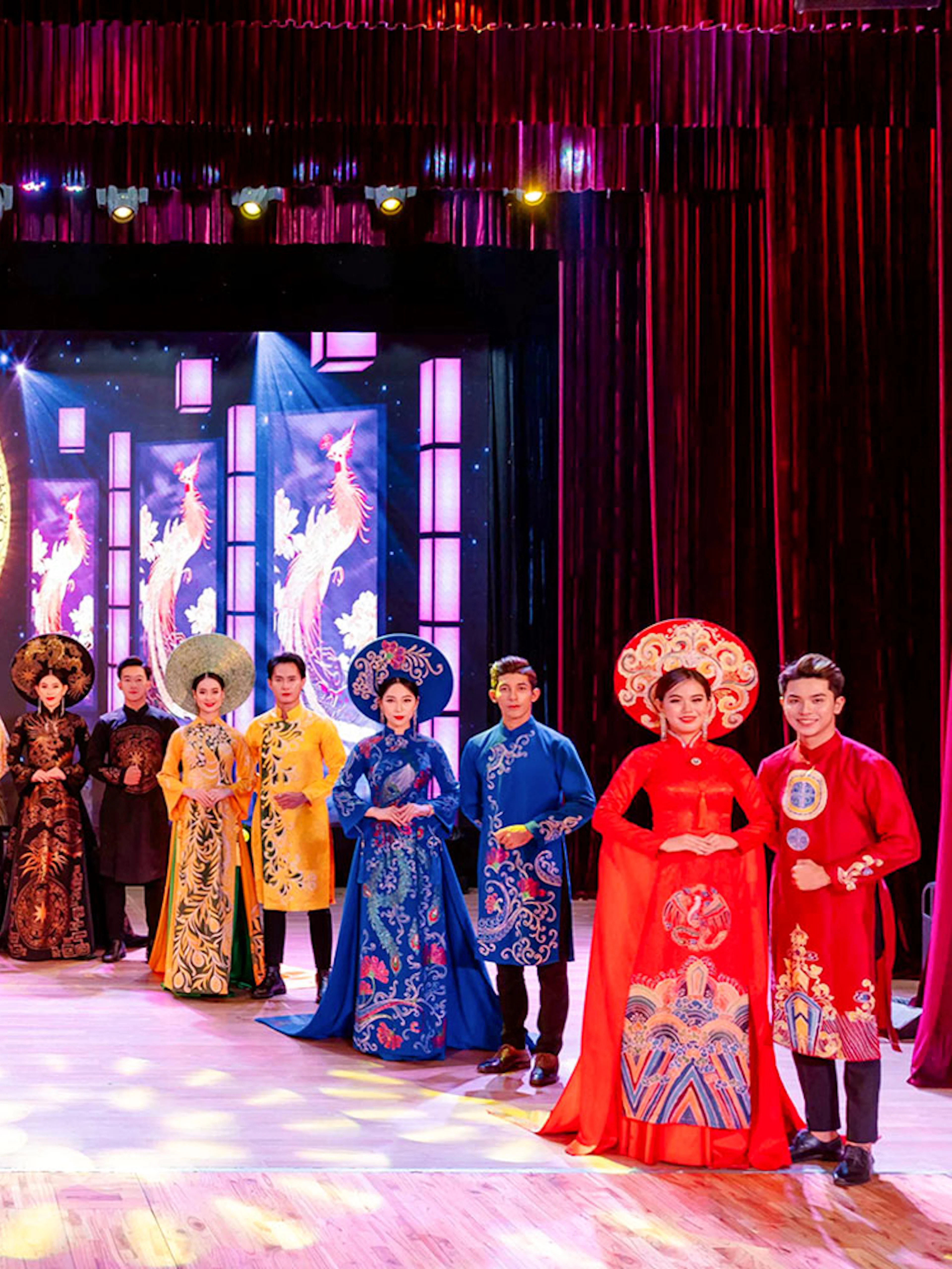 Performers in traditional Ao Dai costumes on stage at the Ao Dai Show in Da Nang.