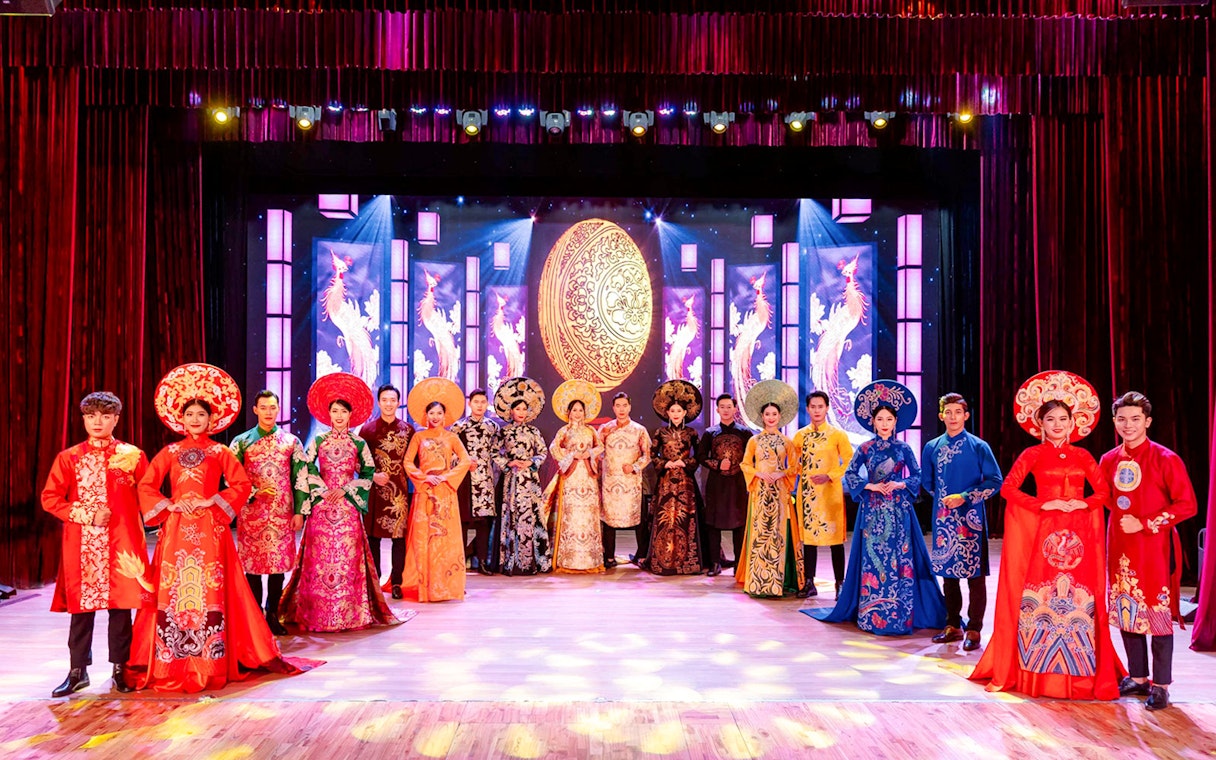 Performers in traditional Ao Dai costumes on stage at the Ao Dai Show in Da Nang.