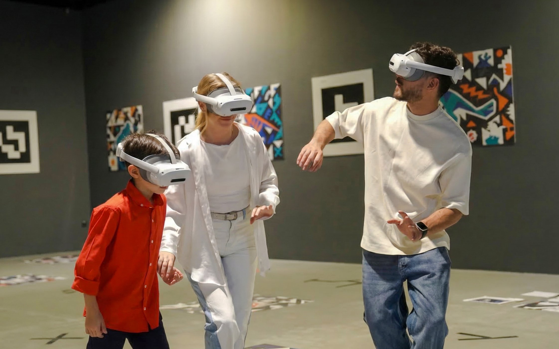 Visitors enjoying VR experience at Dinosaurs: The Immersive Odyssey with museum fossil storage access.