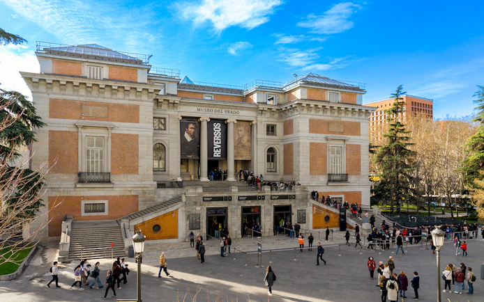 Prado Museum entrance with visitors in Madrid, Spain.