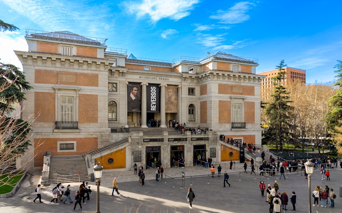 Prado Museum entrance with visitors in Madrid, Spain.