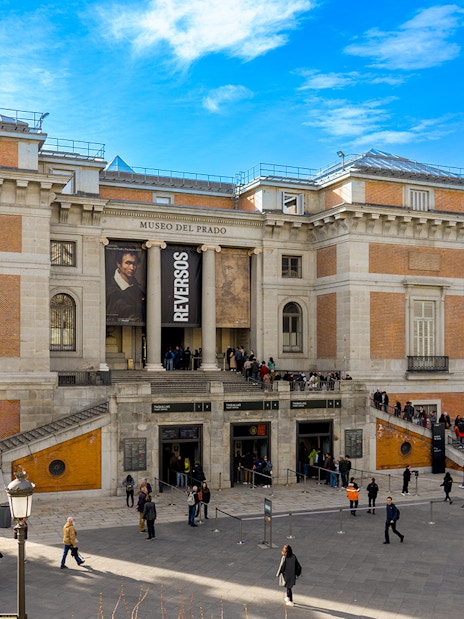 Prado Museum entrance with visitors in Madrid, Spain.