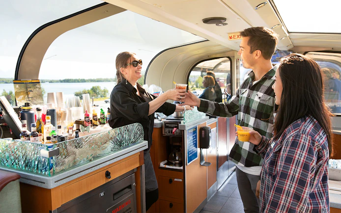 Passengers enjoying drinks in the scenic dome car of the Alaska Railroad.