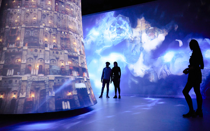 Guests exploring digital art projections at REMASTERED in Rotterdam.