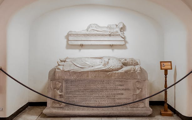 Tomb sculptures in Vatican Grottoes, depicting Papal Tomb with Latin inscriptions.