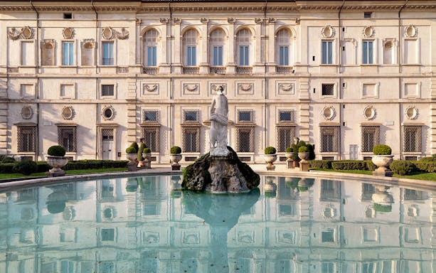Borghese Gallery facade with fountain and statue in Rome, Italy.