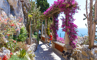 Pathway through Jardin Exotique in Eze with sea view and vibrant flowers.