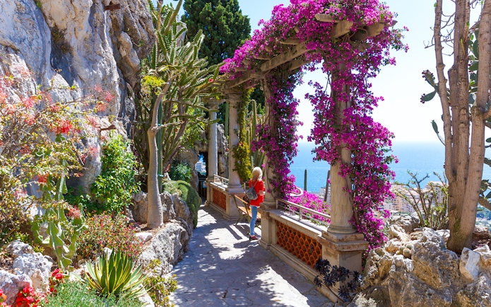 Pathway through Jardin Exotique in Eze with sea view and vibrant flowers.