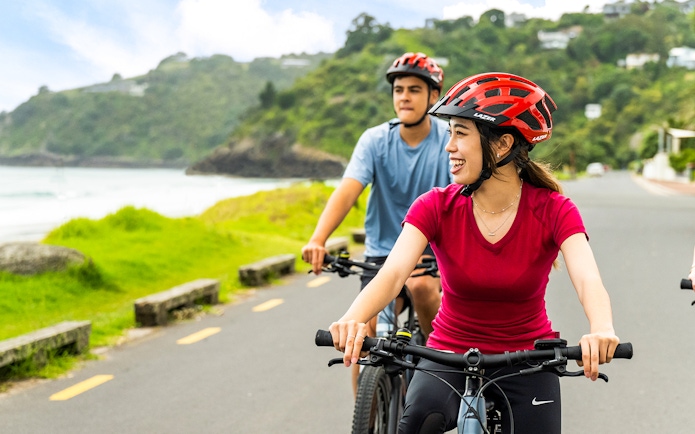 Cyclists enjoying a ride in Waiheke Reserve near the coast.