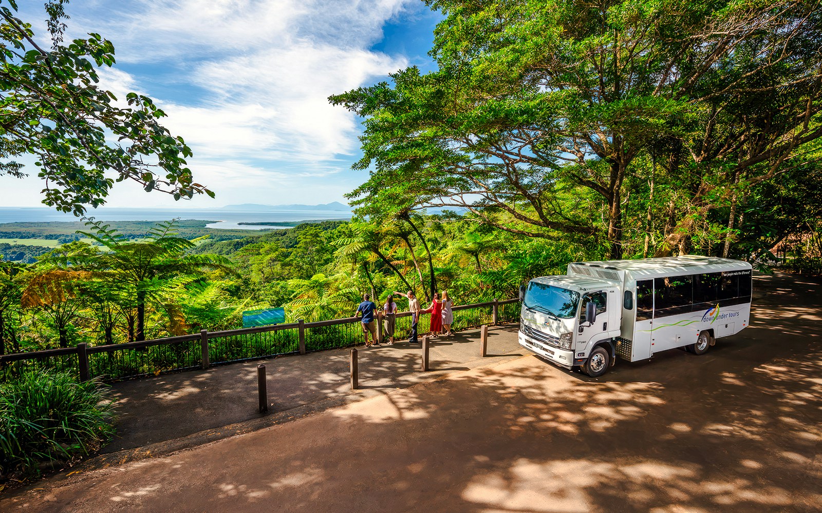 Visitors enjoying the view at Alexandra Lookout, Daintree National Park, with tour bus nearby.