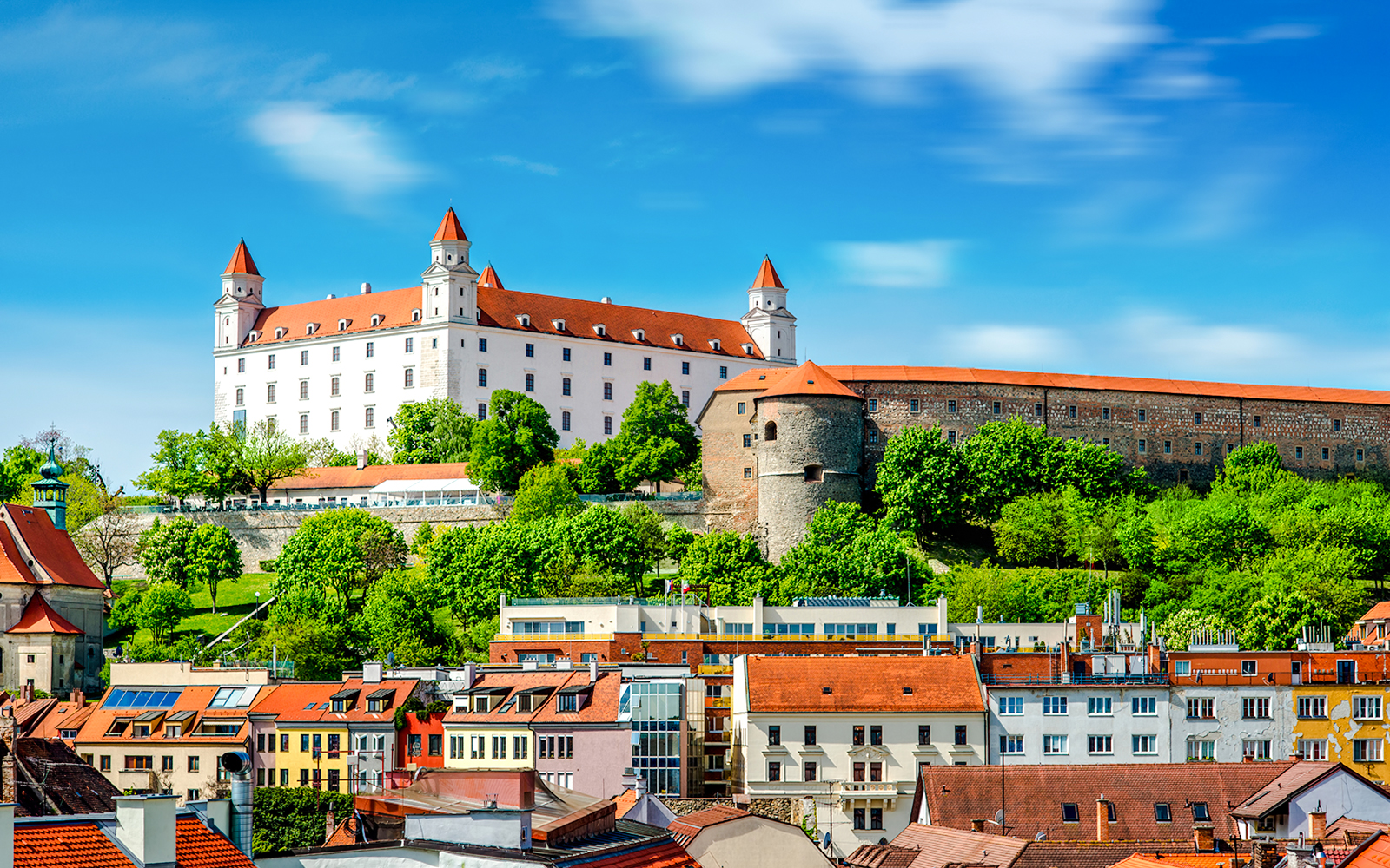 Bratislava Castle overlooking colorful rooftops in Bratislava, Slovakia.