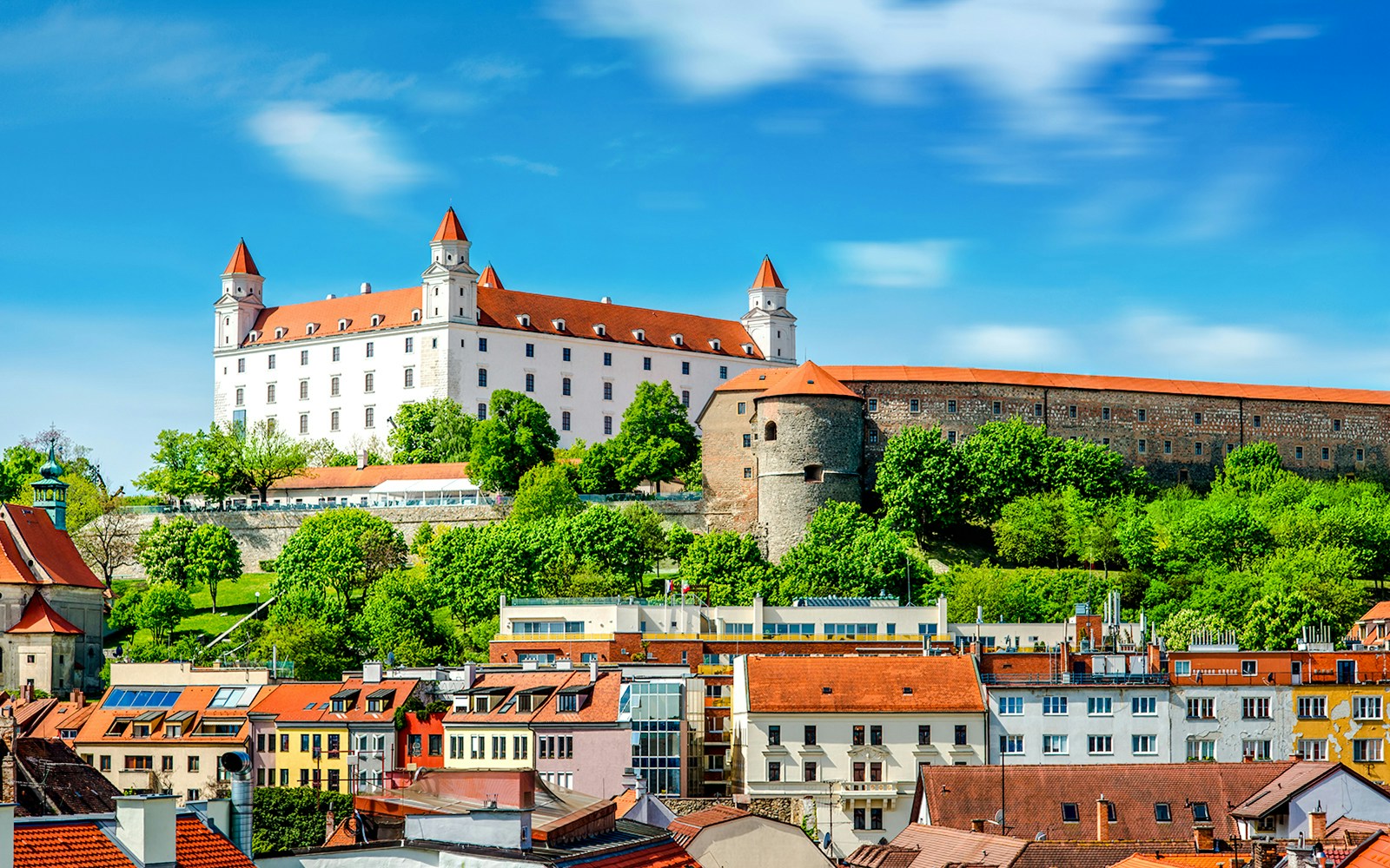 Bratislava Castle overlooking colorful rooftops in Bratislava, Slovakia.
