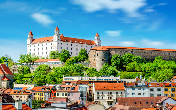 Bratislava Castle overlooking colorful rooftops in Bratislava, Slovakia.