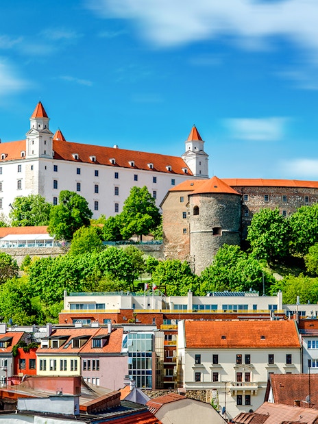 Bratislava Castle overlooking colorful rooftops in Bratislava, Slovakia.
