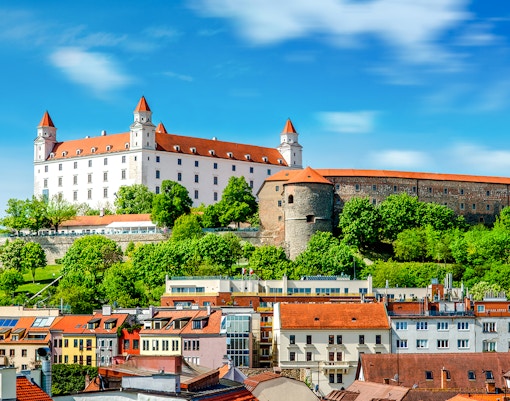 Bratislava Castle overlooking colorful rooftops in Bratislava, Slovakia.
