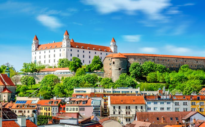 Bratislava Castle overlooking colorful rooftops in Bratislava, Slovakia.