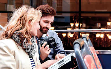 Couple enjoying view on Toronto Hop-On Hop-Off Bus upper deck.