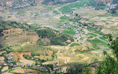 Rice terraces and ethnic villages in Mu Cang Chai, Vietnam, viewed from above.