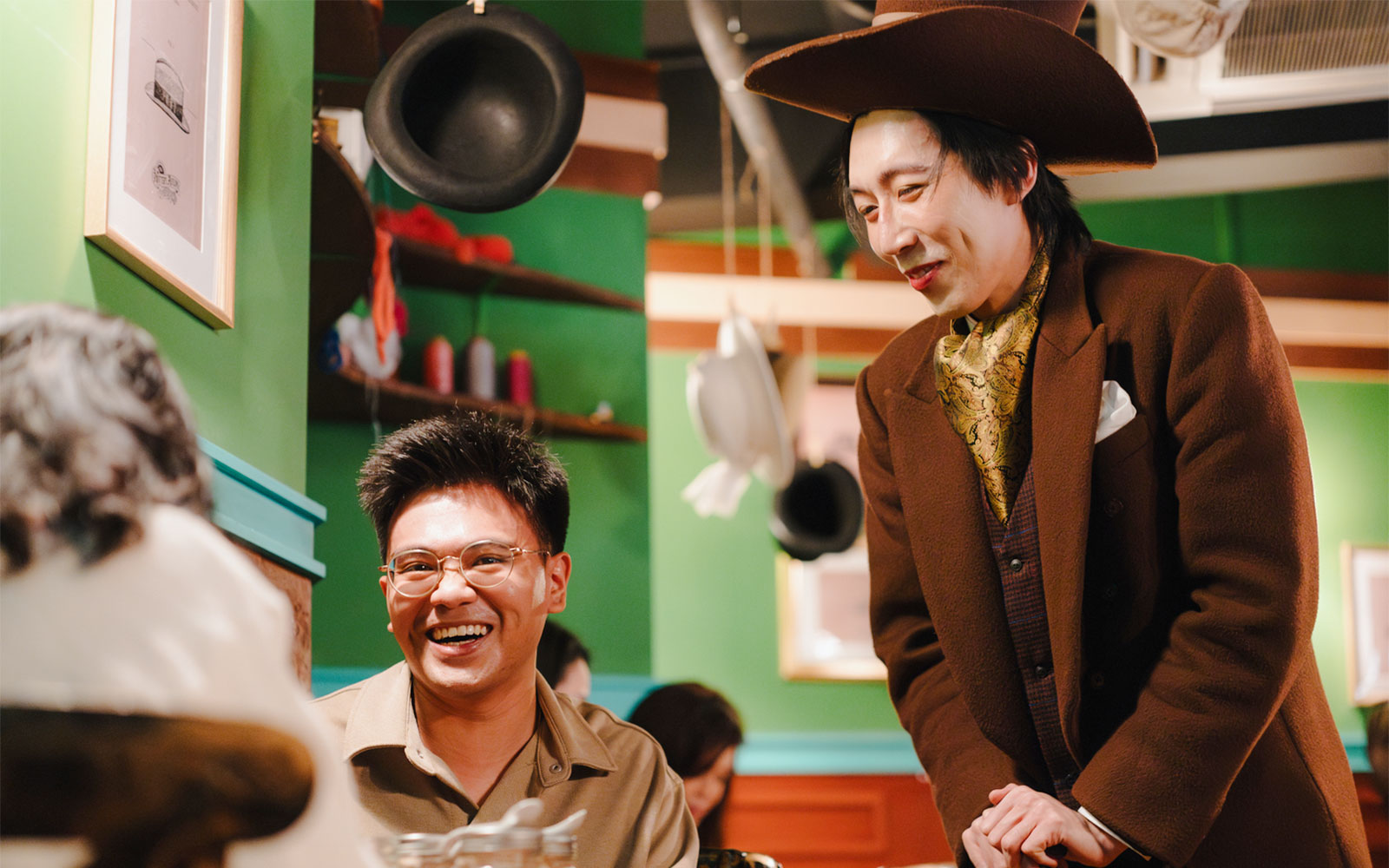 Mad Hatter entertains a guest at the Wonderland Upside Down tea party.
