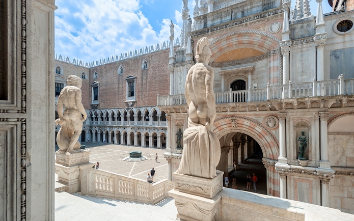 Doge's Palace courtyard in Venice, featuring statues and historic architecture.