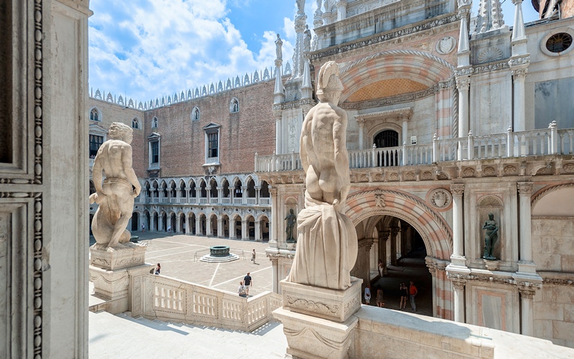 Doge's Palace courtyard in Venice, featuring statues and historic architecture.