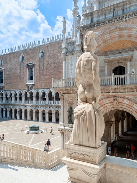 Doge's Palace courtyard in Venice, featuring statues and historic architecture.