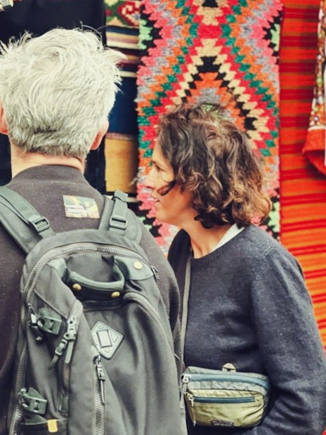 Guests browsing traditional textiles and crafts at Gjirokaster Old Bazaar.