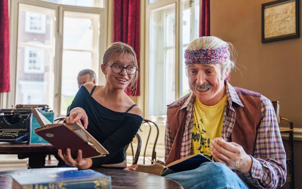 Visitors interacting with a wax figure at the National Wax Museum.