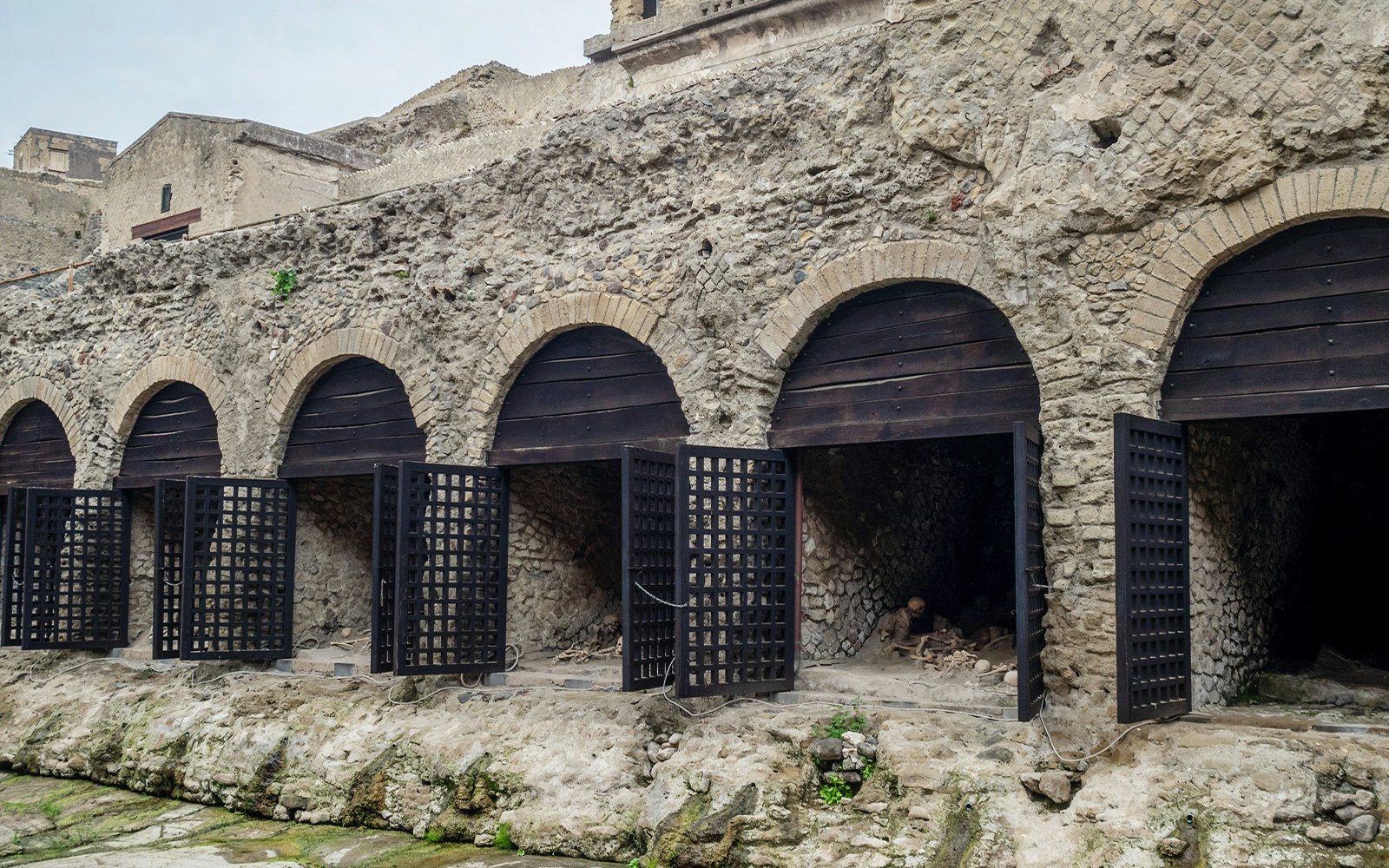 Herculaneum boat sheds with arched entrances and ancient ruins in Italy.