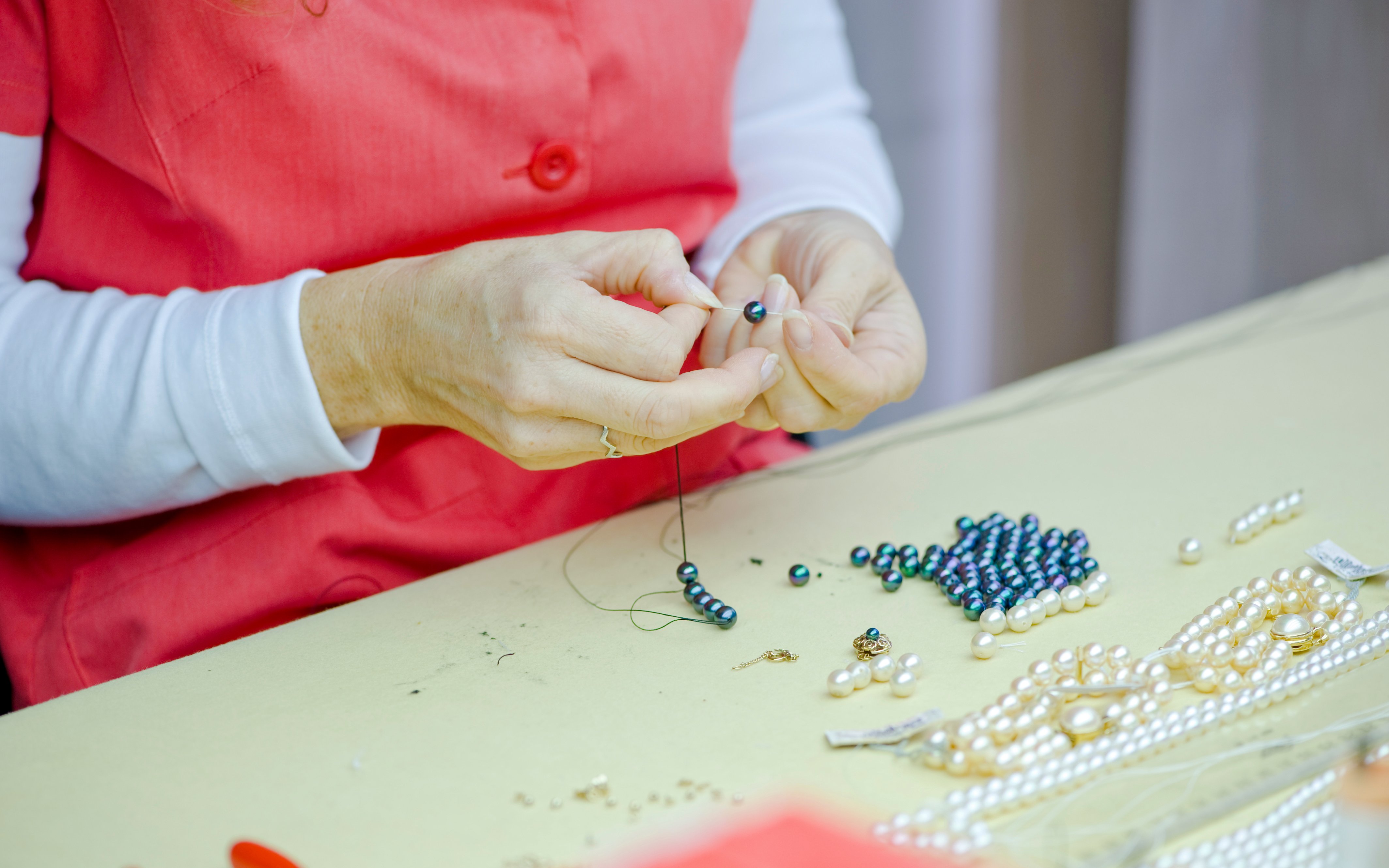 Crafting pearls at a Mallorca factory table.