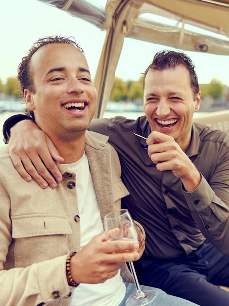 Guests enjoying a canal cruise in Amsterdam with champagne.