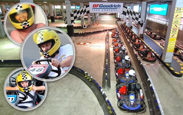 Indoor go-karting track with racers in helmets, Bangkok.