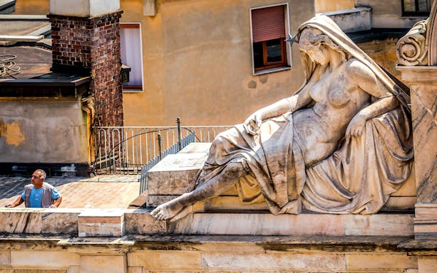 Milan Duomo rooftop statue with visitor on Skip-The-Line tour.