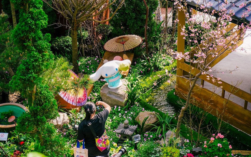 Gardens by the Bay Sakura event with cherry blossoms and character statue.