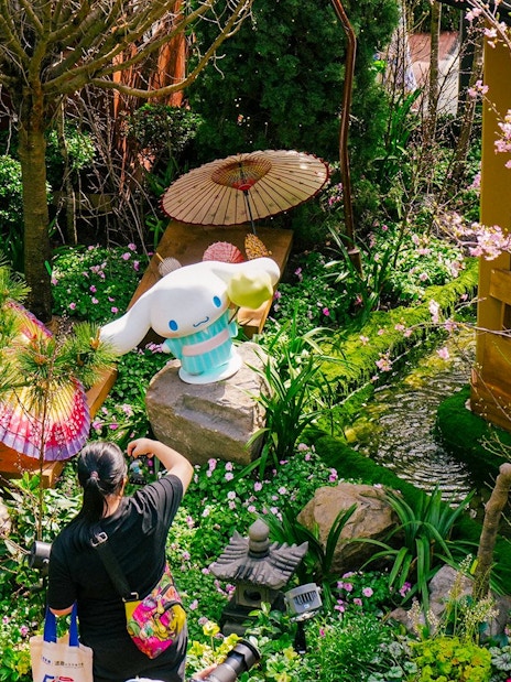 Gardens by the Bay Sakura event with cherry blossoms and character statue.