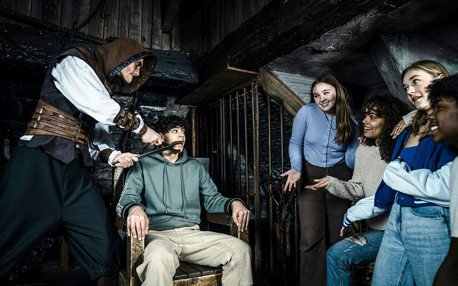 Guests experiencing a theatrical scene at the Amsterdam Dungeon.