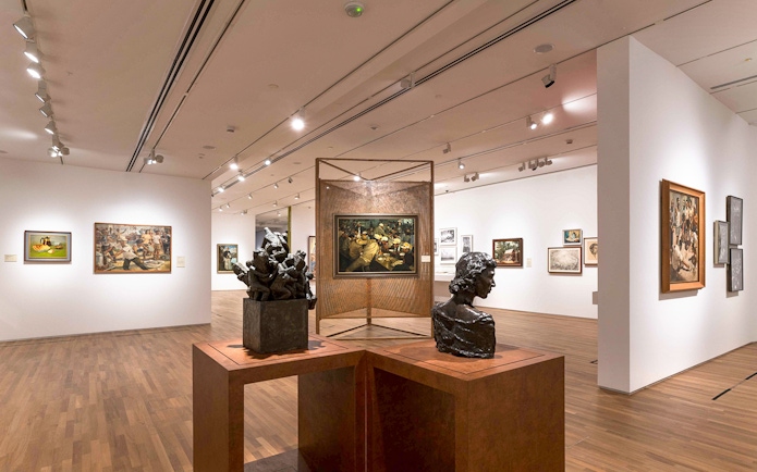 Art sculptures and paintings inside National Gallery Singapore exhibit.