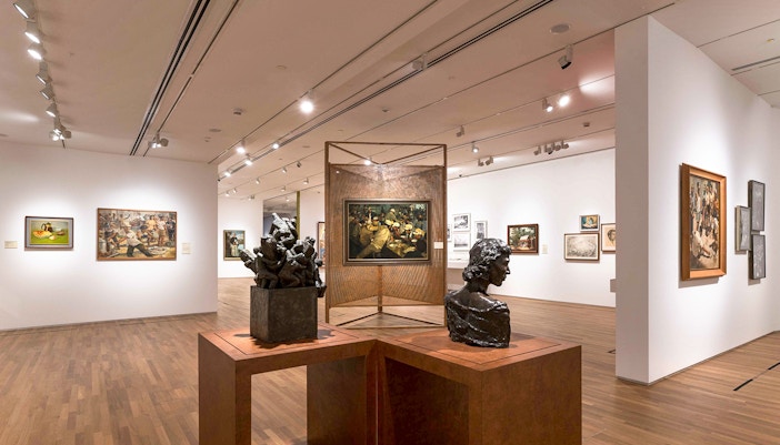 Visitors viewing art pieces inside National Gallery Singapore exhibit.