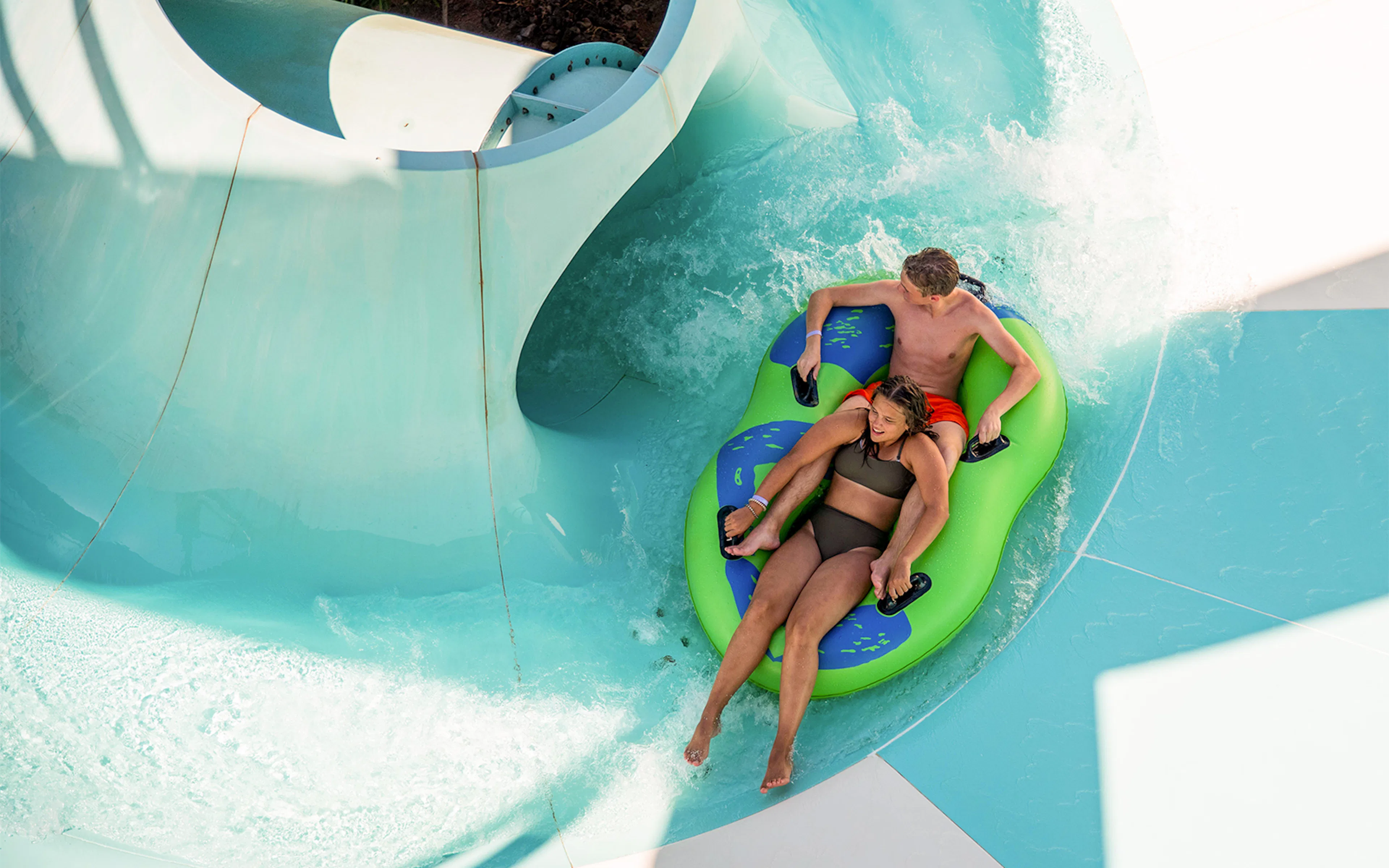 Couple enjoying a water slide at AquaVera Water Park.