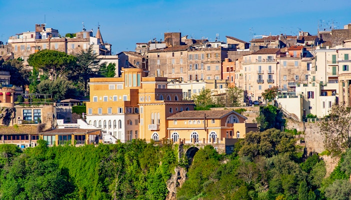 Tivoli townscape with historic buildings and lush gardens, Italy.