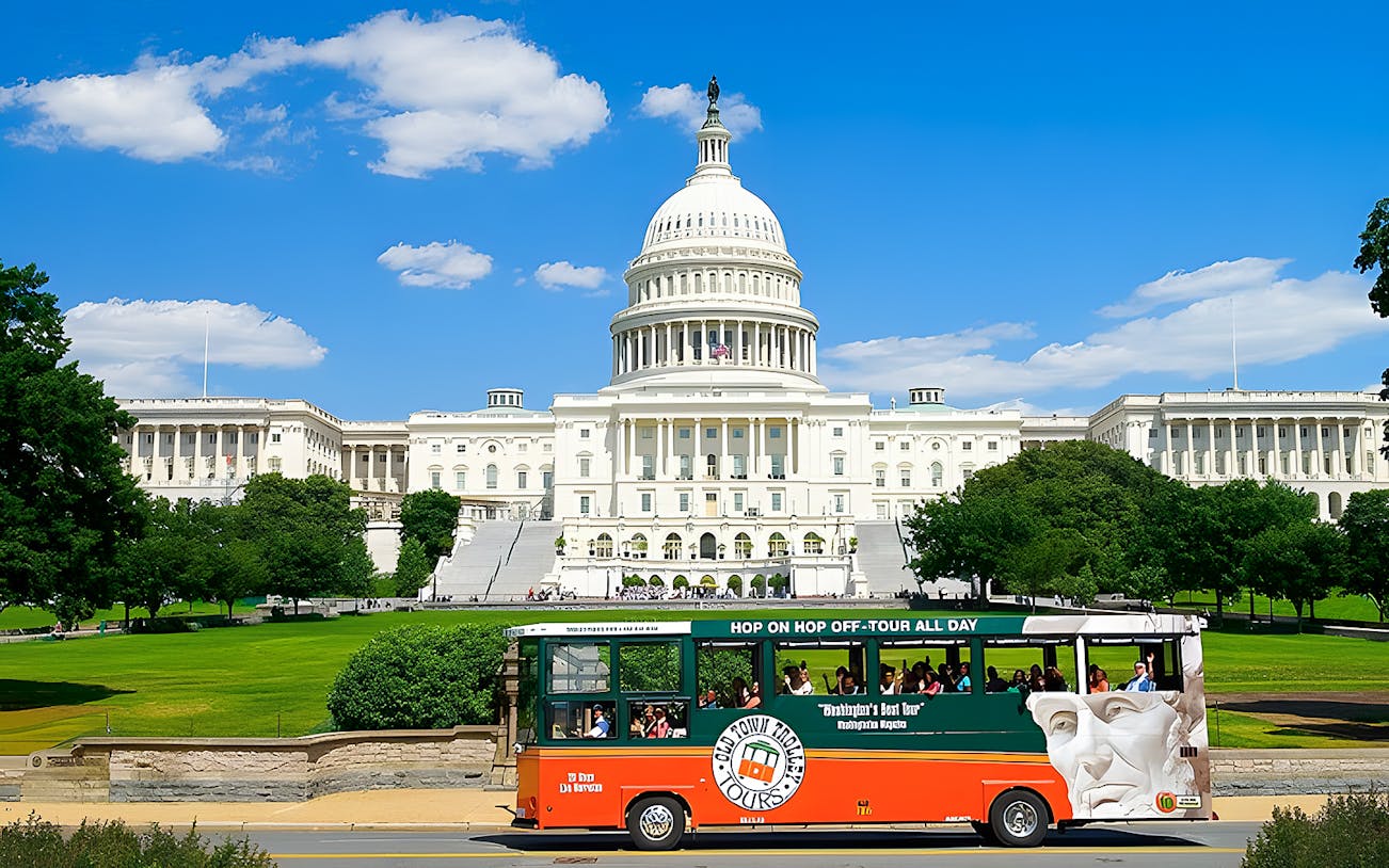 Double-decker bus on Washington DC hop-on hop-off tour passing the US Capitol building.