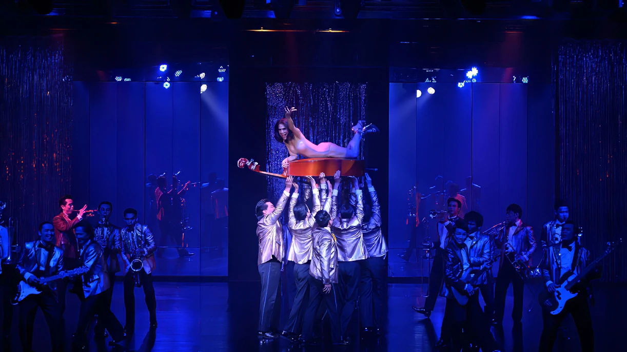 Calypso Cabaret performers in vibrant costumes during a live show, Bangkok.