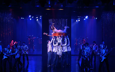 Calypso Cabaret performers in vibrant costumes during a live show, Bangkok.